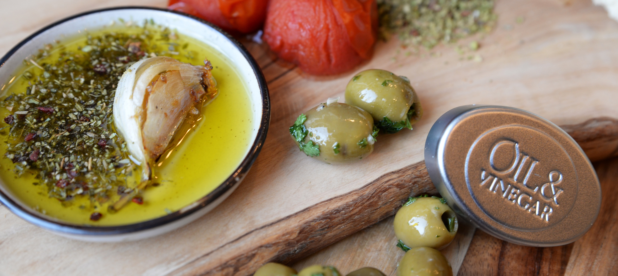 Charcuterie board with oils, vinegars, and a variety of dried spices. Ideal for dipping, seasoning, and entertaining.